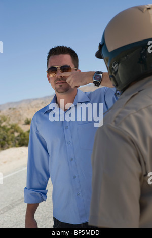 Police office runs sobriety test on male driver Stock Photo