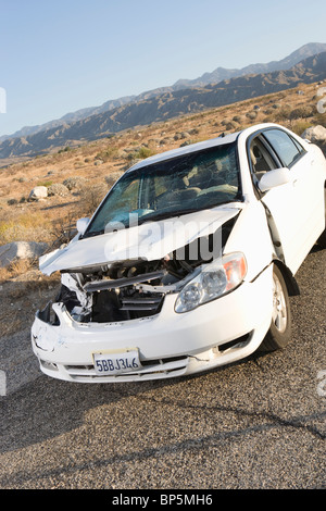 Damaged car in desert Stock Photo