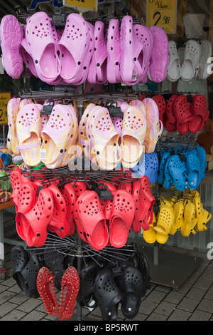 Cheap fake imitation Crocs made in China for sale on a display stand outside a shoe shop Stock Photo