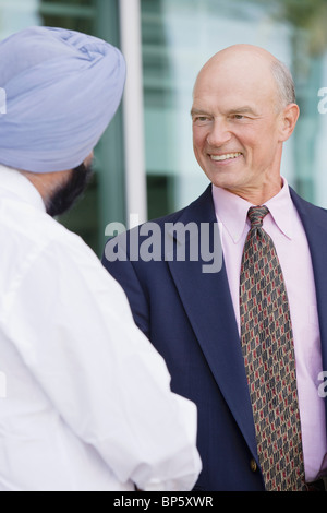 Two Businessmen Shaking Hands, Rear View Stock Photo