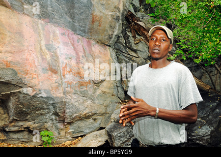 Guide showing the petroglyphs at Tsodilo Hills, UNESCO world heritage site, Botswana, Africa Stock Photo