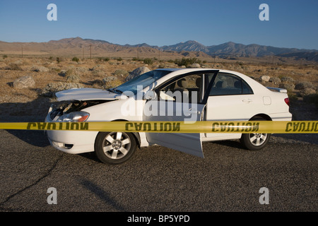 Damaged car in desert Stock Photo