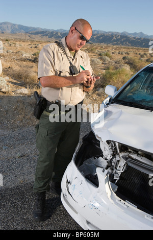 Police officer takes car crash details Stock Photo