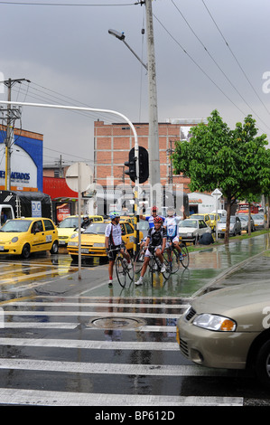Four cyclists in the rain. Medellin, Colombia Stock Photo