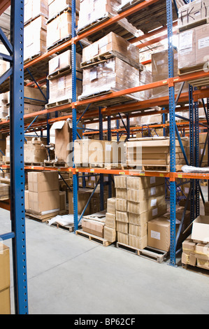 Cardboard boxes on shelves in distribution warehouse Stock Photo