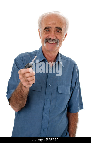 Elderly man holding a car key and looking at camera Stock Photo