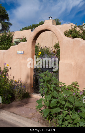 Arched front gate to a house in the Pueblo revival style architecture of the Southwest in Santa Fe, New Mexico Stock Photo