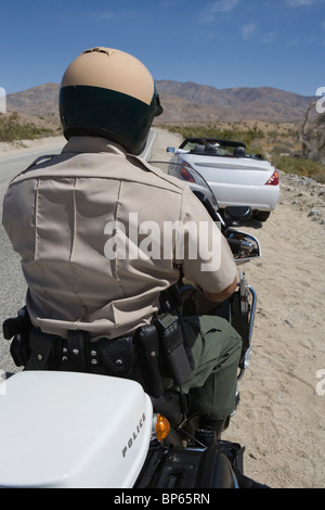 Motorcycle police officers sits on his vehicle Stock Photo