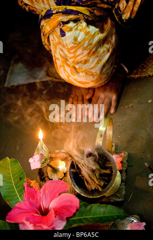 Muslim woman praying at family alter, Bangladesh Stock Photo