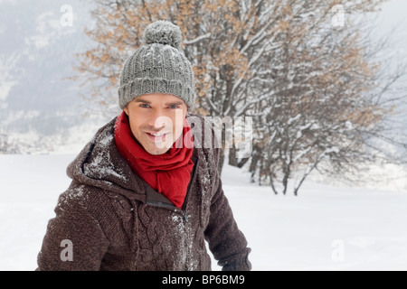 Young man in winter clothes smiling at camera Stock Photo