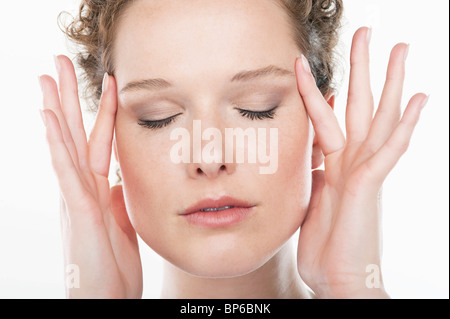 Close-up of a woman rubbing temples Stock Photo