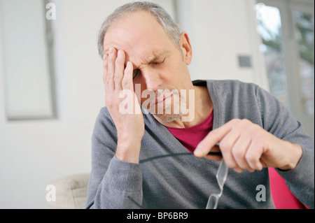 Close-up of a man suffering from a headache Stock Photo