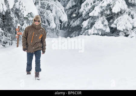 Young man walking in snow Stock Photo