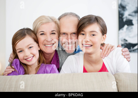 Couple smiling with their granddaughters Stock Photo
