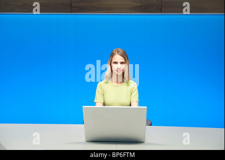 Businesswoman working on a laptop in a conference room Stock Photo