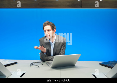 Businessman working on a laptop in a conference room Stock Photo