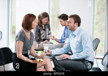 Business executives talking to each other Stock Photo