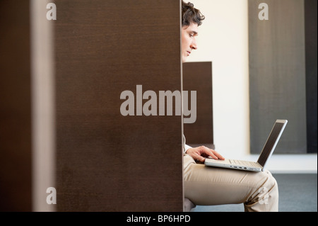 Businessman working on a laptop in an office Stock Photo