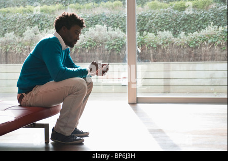 Man text messaging on a mobile phone Stock Photo