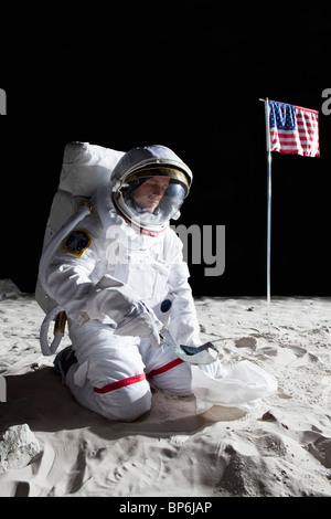 An astronaut on the moon collecting a soil sample Stock Photo