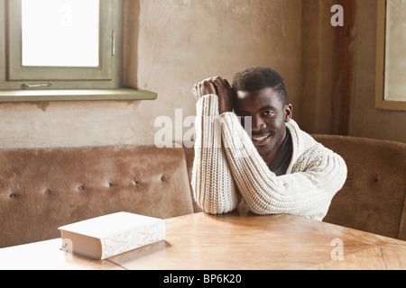 A young man sitting at a table Stock Photo