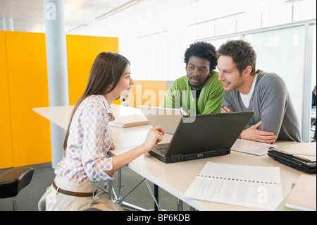 Business executives using laptops in an office Stock Photo