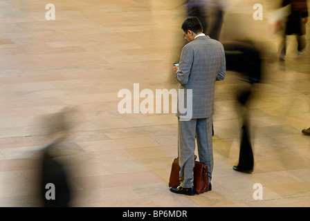 Business Man Looking at Cell Phone in Station Stock Photo