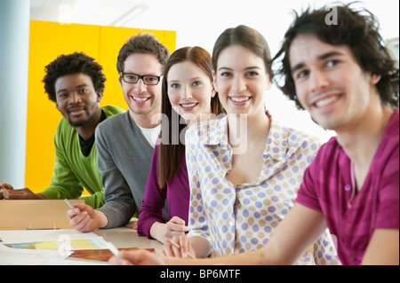 Business executives smiling in an office Stock Photo