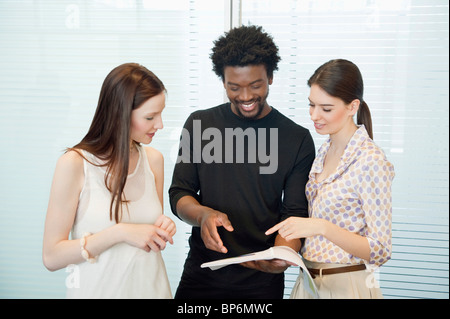 Business executives discussing documents in an office Stock Photo