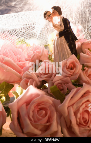 Detail of roses and a wedding cake figurine Stock Photo