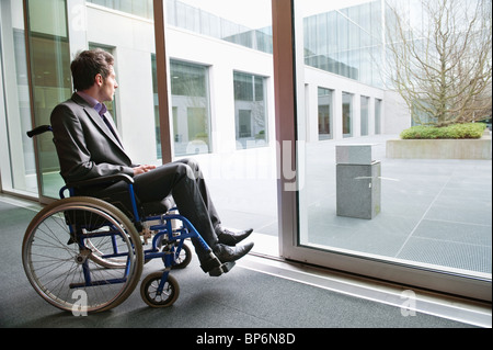 Disabled businessman sitting in a wheelchair Stock Photo