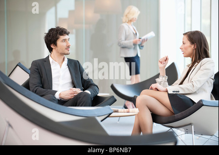 Business executives discussing in a waiting room Stock Photo