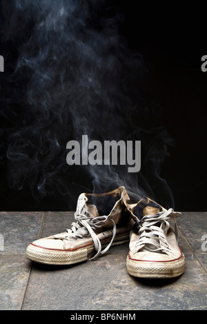 Smoke coming from burnt canvas shoes Stock Photo
