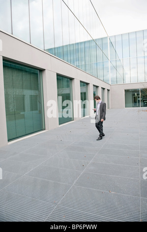 Businessman text messaging on a mobile phone Stock Photo