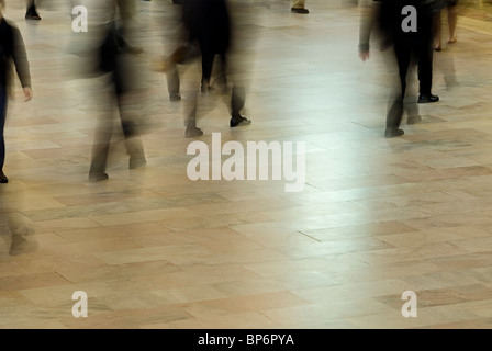 Commuters rush through station Stock Photo