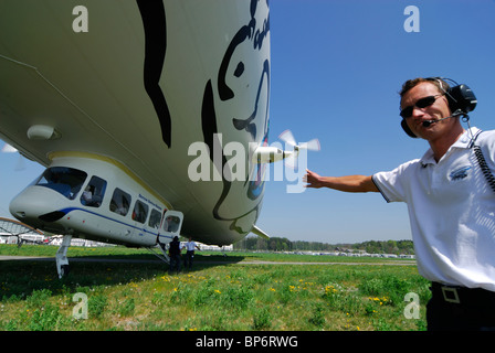 Member of ground crew supervising boarding of airship dirigible Zeppelin NT, Friedrichshafen, Baden-Württemberg, Germany Stock Photo