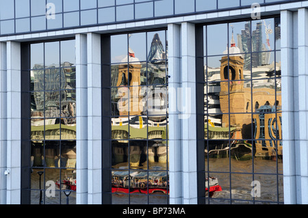 Southwark Bridge, River Thames and City of London buildings reflected in a window, London, England, UK Stock Photo
