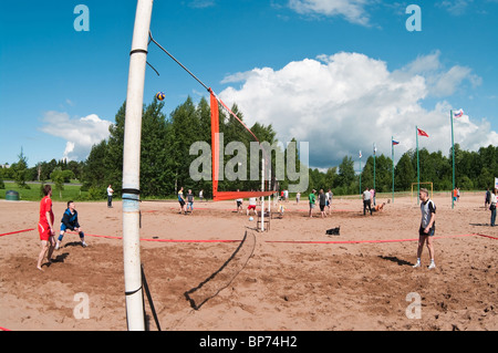 Volleyball ground on sand beach and sportsmen playing the game. Sestroretsk, Russia Stock Photo