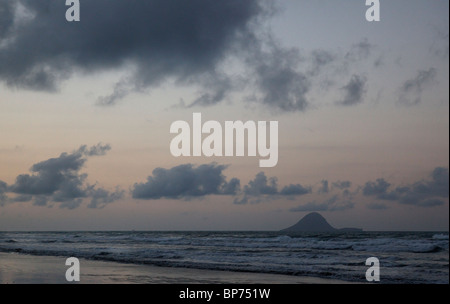 A sunset over Ohope Beach with Whale Island and the moon in the background, New Zealand Stock Photo