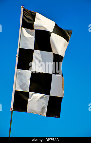 Checker flag against blue sky