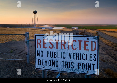 Restricted Access sign along the California Aquaduct at sunset in the Central Valley, near Los Bano, Merced County,California Stock Photo