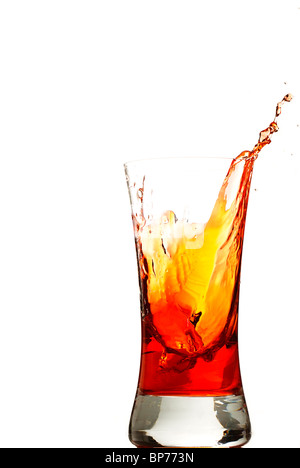 one ice cube falls in one glas with red liquid Stock Photo