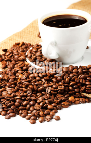 coffee beans near coffee cup and jute on white background Stock Photo