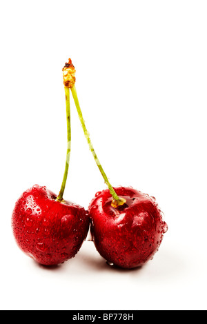 two wet cherries on white background Stock Photo