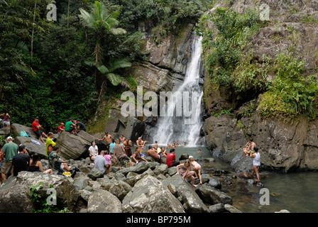 Tourists and locals mingle at La Mina waterfall, El Yunque rain forest,Puerto Rico, Stock Photo