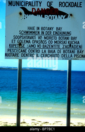 Multi-language sign warning about the danger of swimming because of sharks in Botany Bay near Sydney Stock Photo