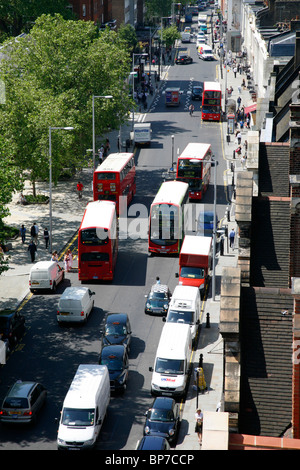 Roofline view of buses moving along King's Road, Chelsea, London, Britain Stock Photo