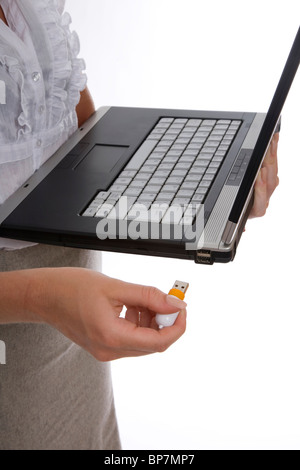 Woman using usb memory stick on laptop - crop Stock Photo