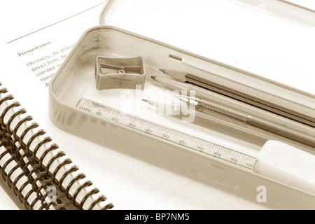 Metal pencil case and book close up Stock Photo