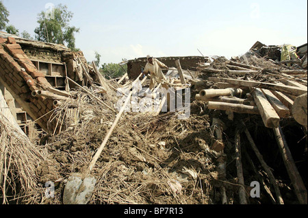 Man looks the debris of his house after flood at Aza Khel area in Nowshera Stock Photo